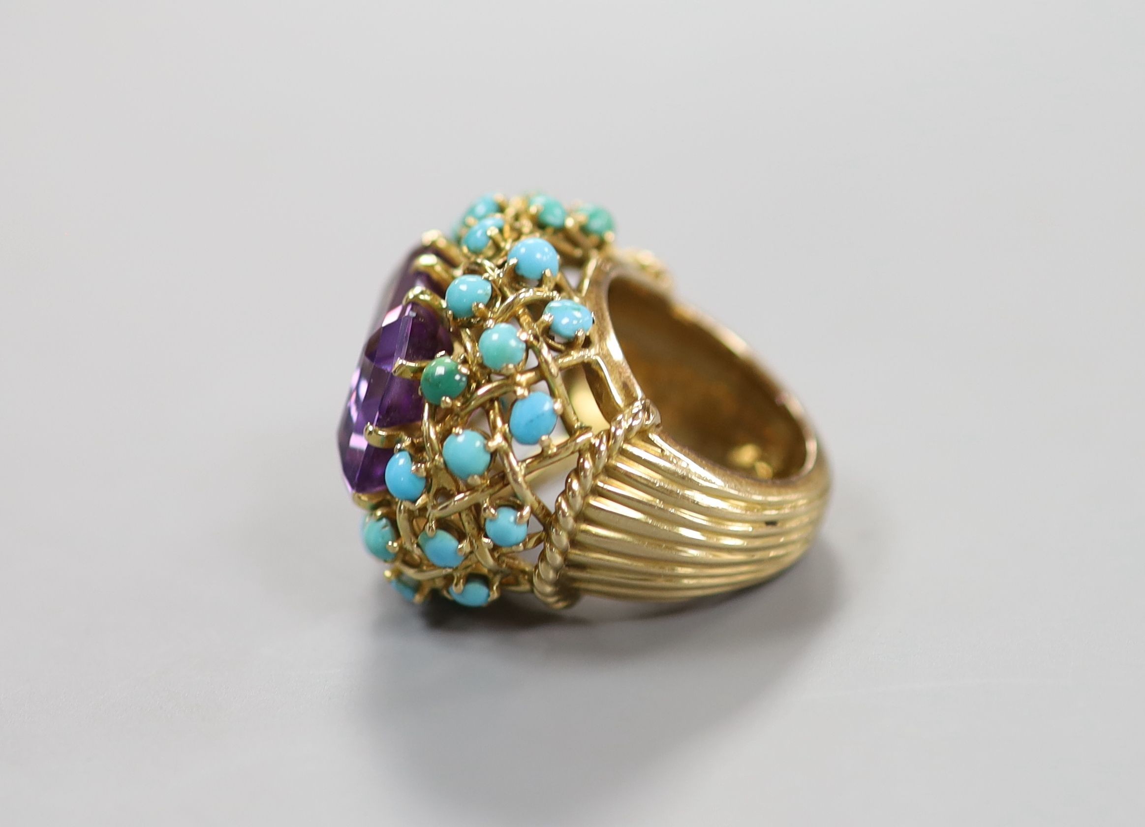 A French yellow metal (18ct poincon mark), amethyst and turquoise set cluster dress ring, with ribbed shank, size J, gross weight 19.2 grams.